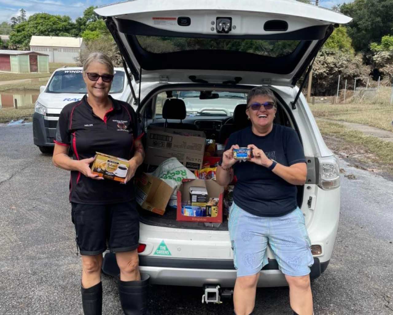 GSL community volunteers with a car loaded with food supplies